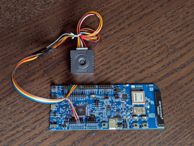 An electronic development board connected to a camera module with a few colorful wires