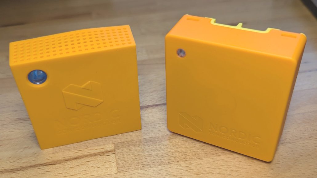 Two small orange boxes side by side on a wooden butcher block desktop